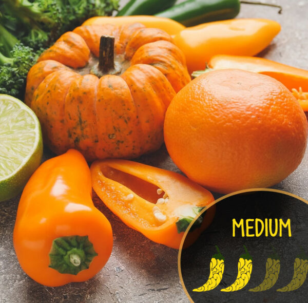 Assorted vegetables including a pumpkin, orange, and Pumpkin Spice Jalaeno peppers on a textured surface.