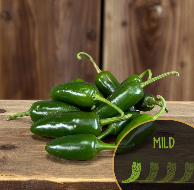 Green jalapeño peppers on a wooden surface with a 'MILD' label.